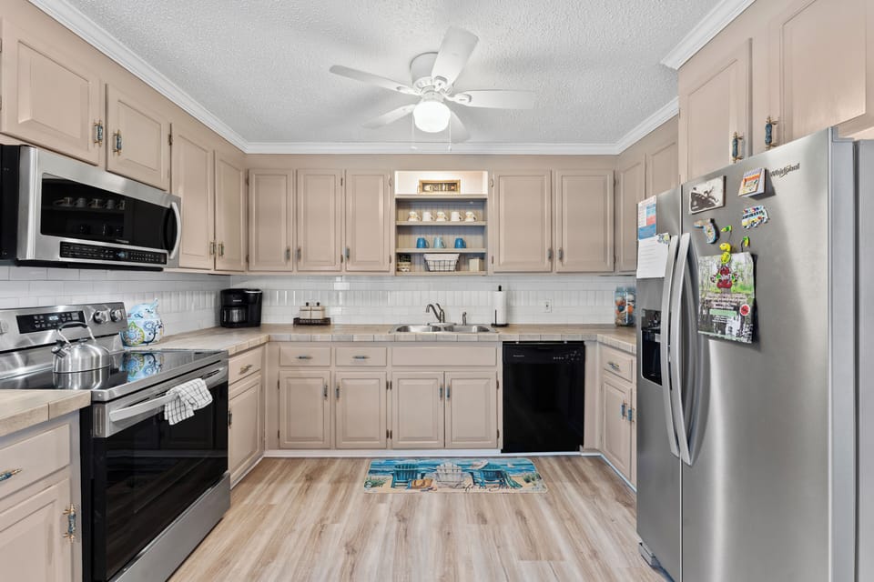 Kitchen features stainless steel appliances.
