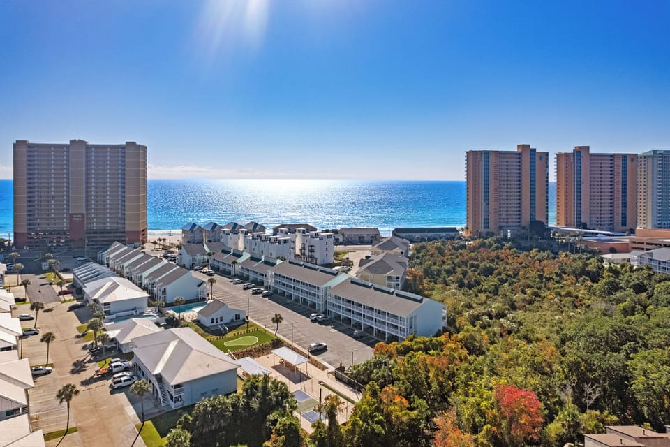 Aerial view showing the nearby beach and neighborhood.