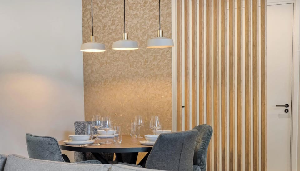 Wooden accents add warmth to the dining area, creating a calm and modern atmosphere.