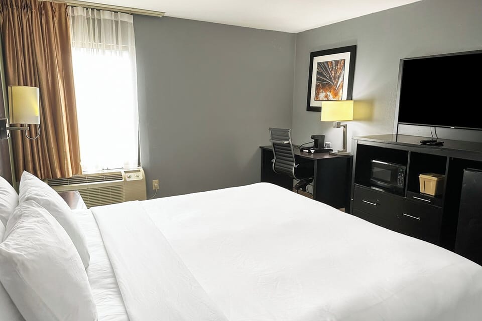 Recharge on plush bedding with a convenient in-room workspace.
