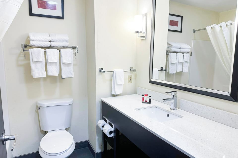 Enjoy fresh towels and a tidy, well-lit bathroom setup.