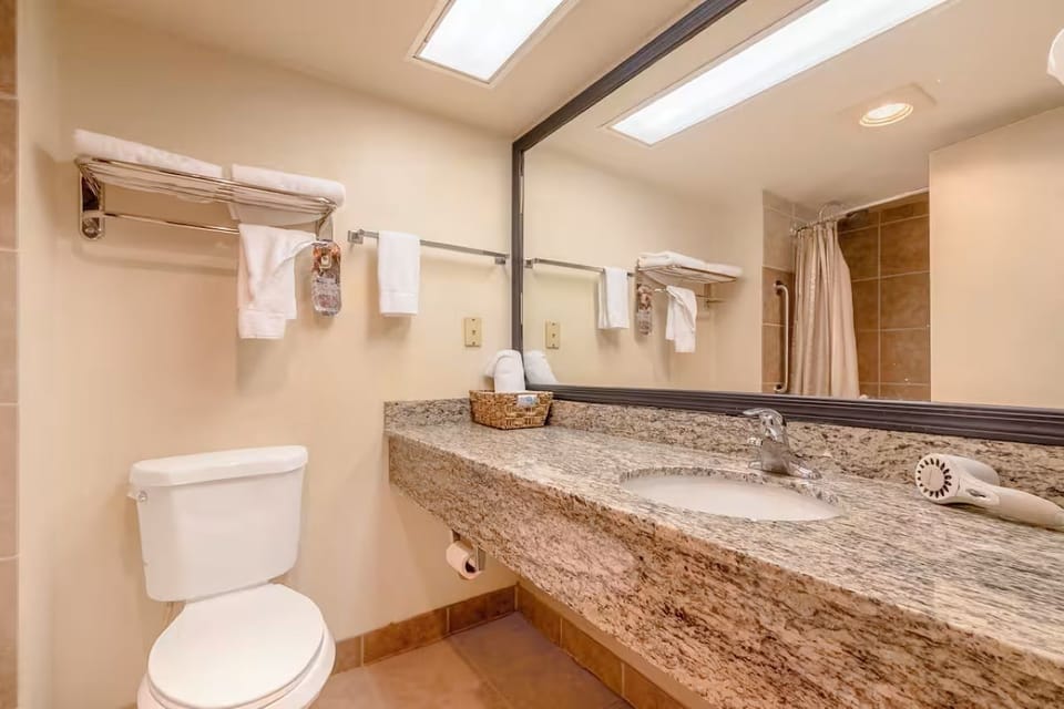 Get ready with a wide vanity and fresh towels nearby.