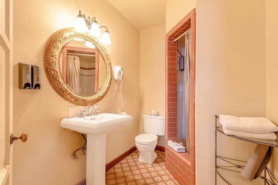 Refresh comfortably with a clean shower and bright vanity lighting.