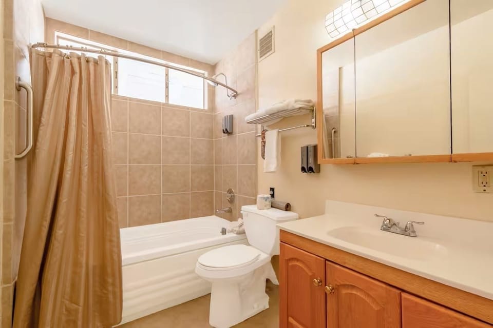 Refresh easily with a clean tub-shower and bright vanity.