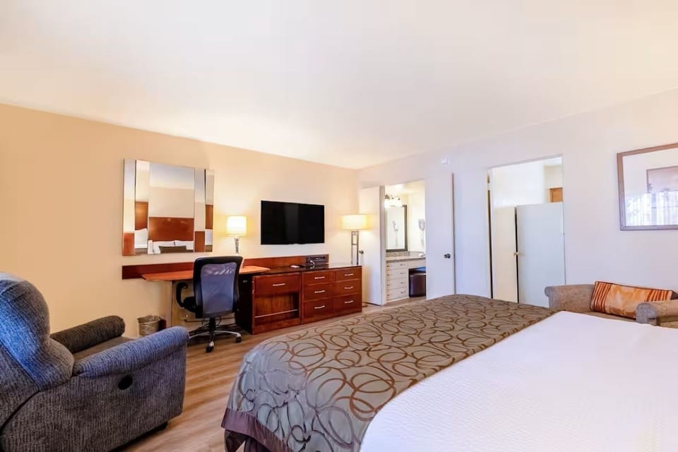 Recharge in a roomy bedroom with dedicated workspace convenience.