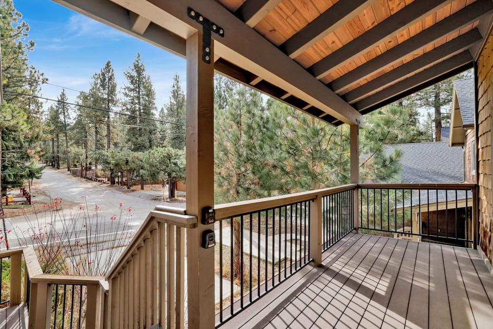 Welcoming cabin entry surrounded by towering pine trees, offering fresh mountain air and a peaceful forest setting—the perfect first impression for your Big Bear Lake getaway.