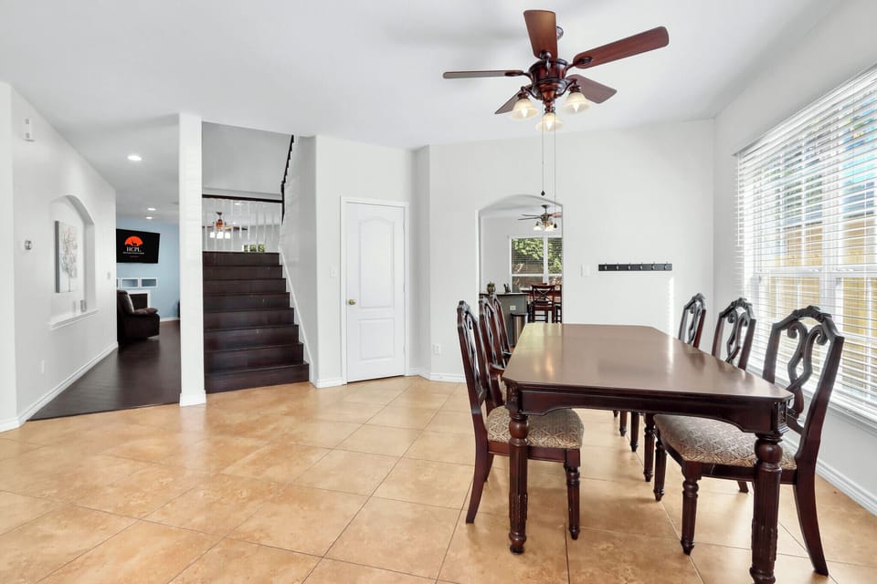 Stairs to the upper level and hallway to additional living spaces