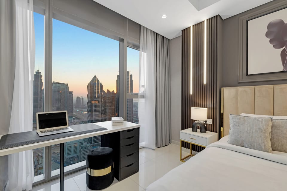 Cozy bedroom with premium bedding and relaxing city views.