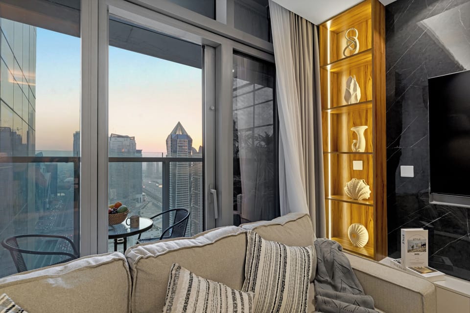Spacious living room with comfy seating and city views.