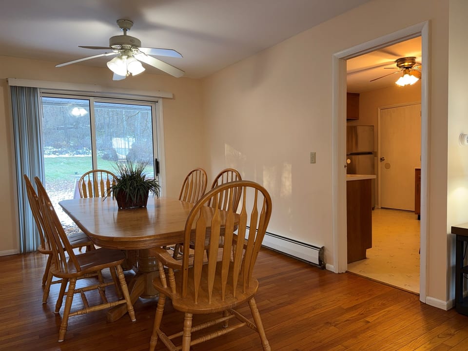 Dining table, sliding doors to back deck and kitchen