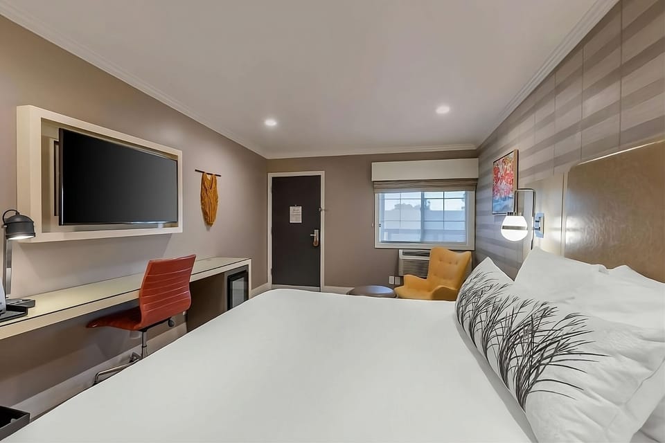 Settle in with a spacious desk, big TV, and crisp linens.
