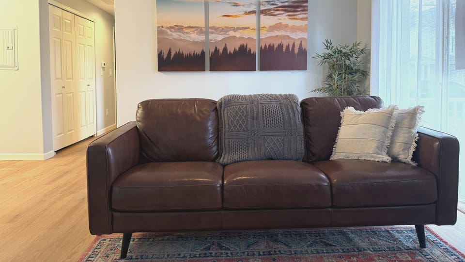 Sink into this luxurious leather sofa where you'll unwind after exploring the city. Soft throws and plush pillows create your perfect spot for morning coffee or evening relaxation.