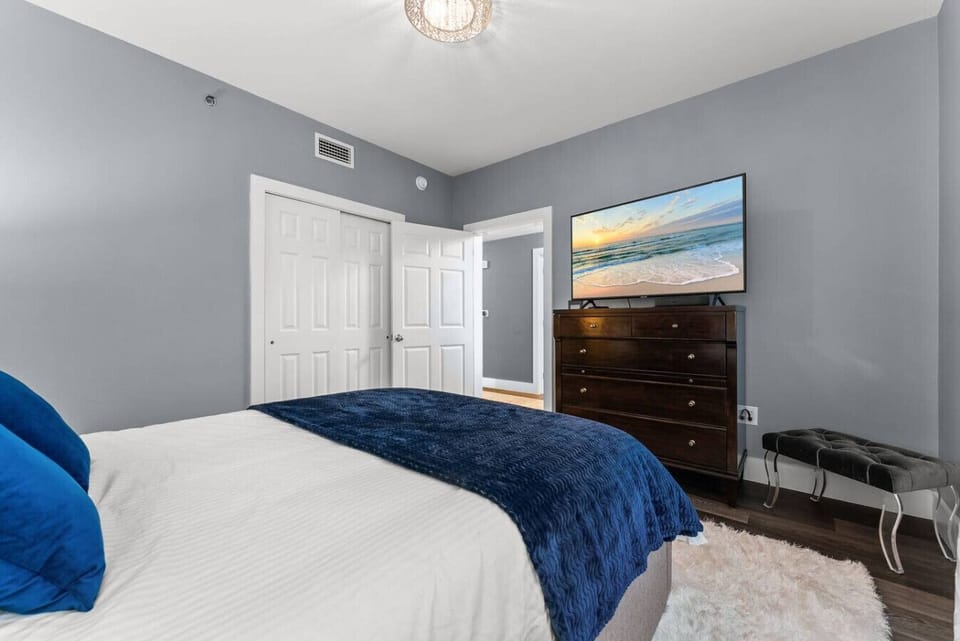 Third bedroom featuring a large smart TV and plenty of dresser storage for extended stays.