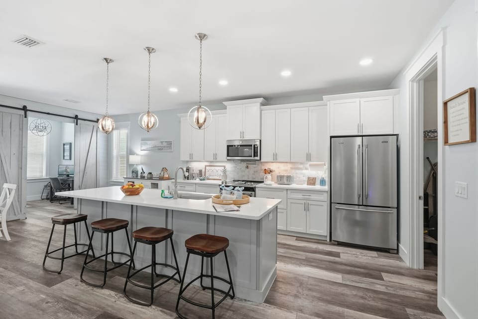 Sit back at your huge island and eat in kitchen with your favorite drink, a charcuterie board and friends and family as you prepare for your family meal.