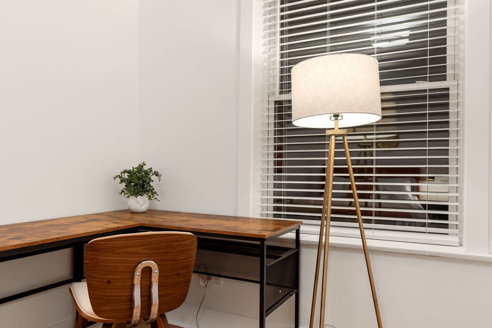 Inviting nook w/ seating, lamp & artwork adding warmth to the room.