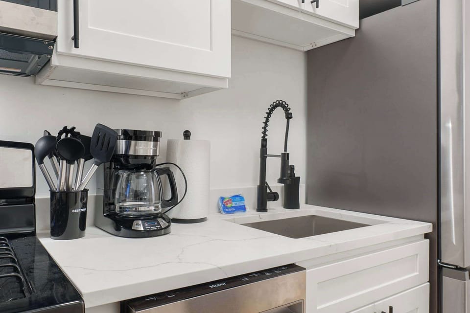 Coffee station setup w/ modern appliances for easy mornings.