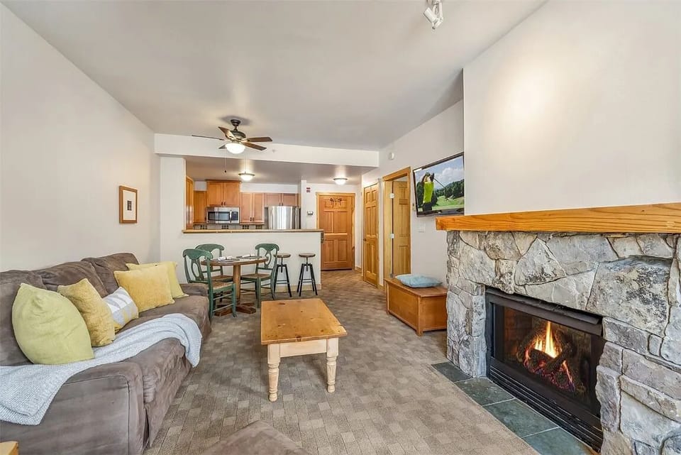Living room with gas fireplace, pullout sofa, & mountain views