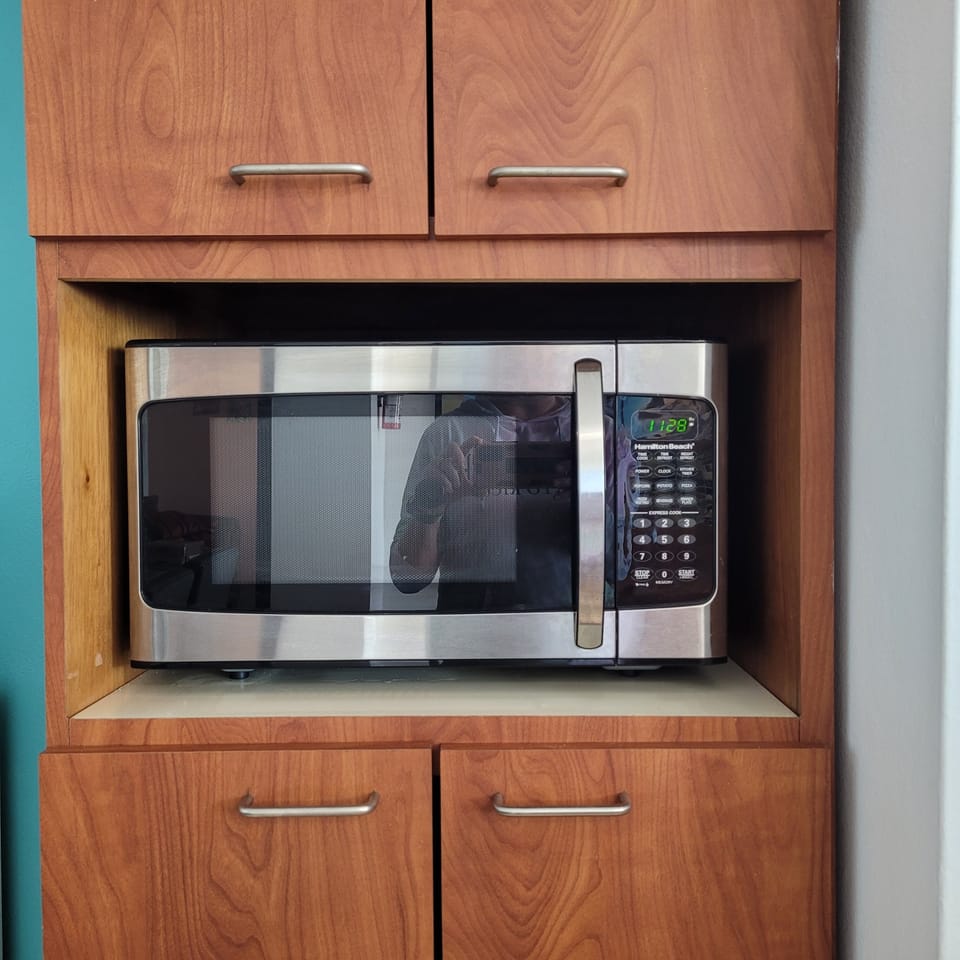 Microwave and plenty of cabinetry for your food.