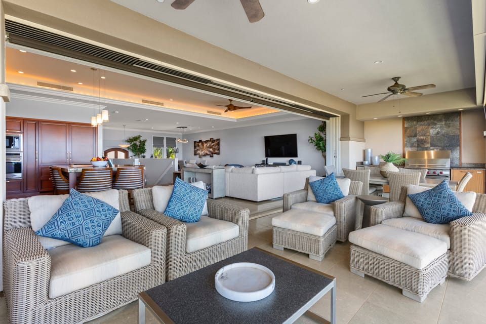 Comfortable wicker furniture and open views make this lanai ideal for gatherings or quiet moments