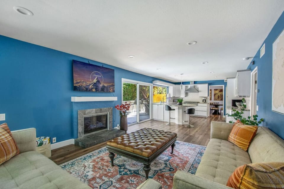 Living area with smart TV and cozy seating.