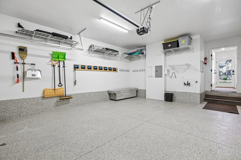 Spacious, spotless garage with epoxy floors and organized storage