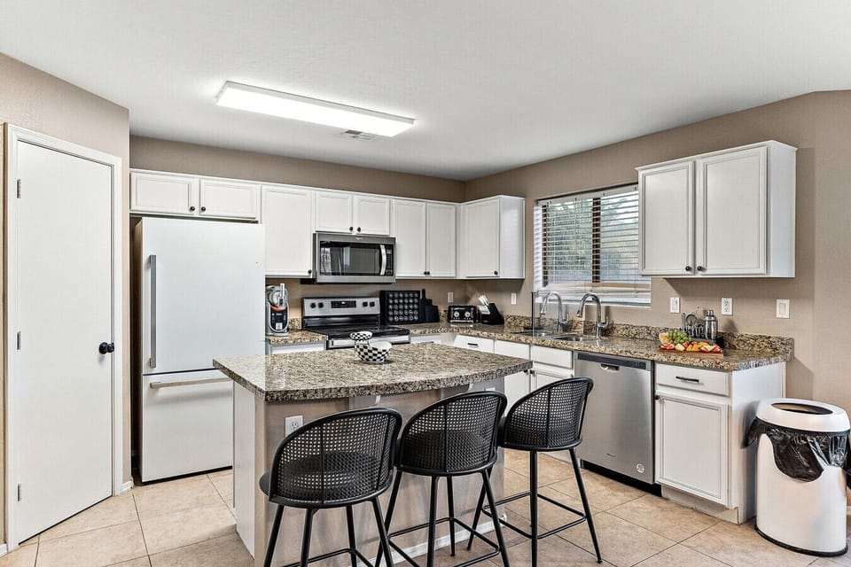 “Fully equipped kitchen with spacious countertops and bar seating—perfect for cooking, snacking, and gathering.”