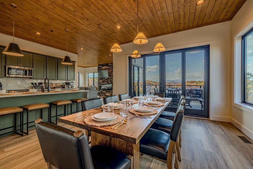 Share group meals at the live-edge dining table with a scenic backdrop of the hills