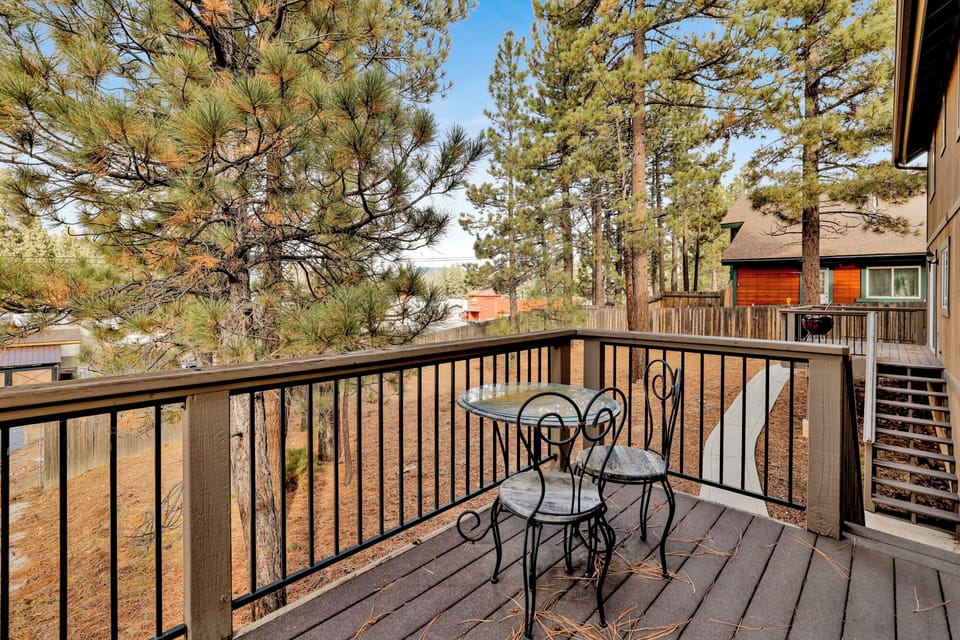 Private outdoor deck with a BBQ, surrounded by tall pines, perfect for relaxing under the trees after a day of adventure—enjoy peaceful forest views, fresh air, and a truly rejuvenating stay.