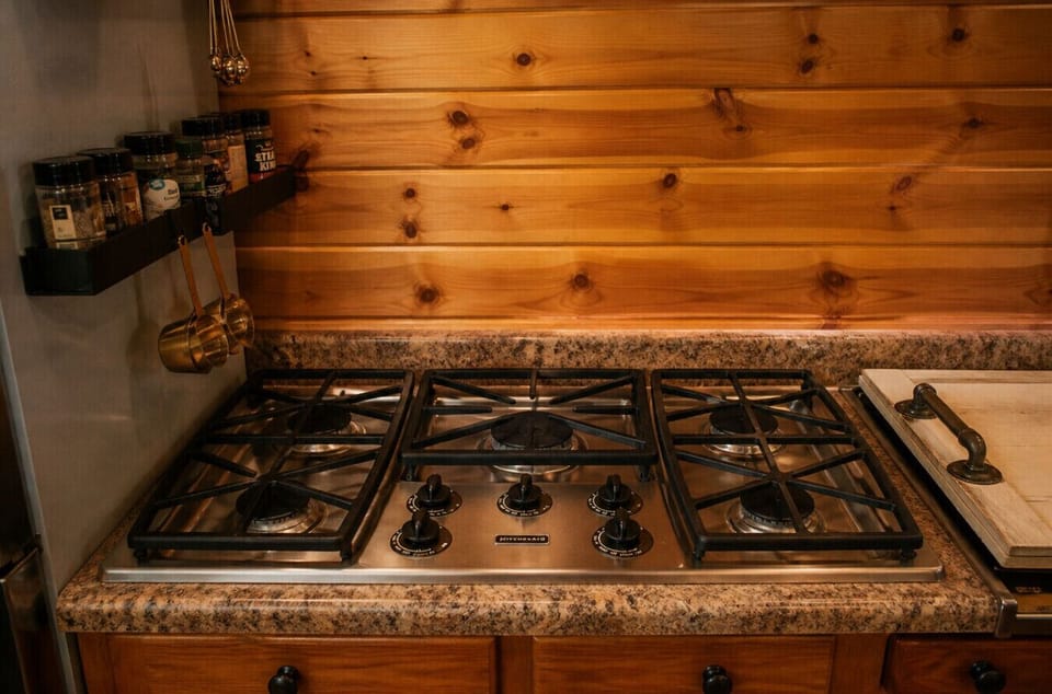 Five-burner gas stove and fully equipped kitchen designed for group cooking and extended stays