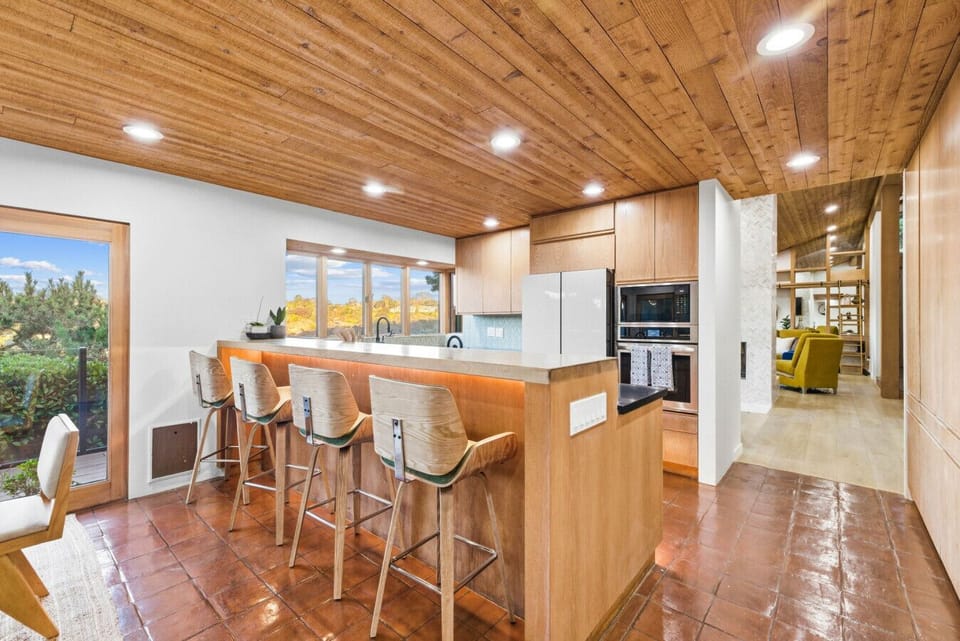 Open-concept kitchen and dining area with inviting bar seating.