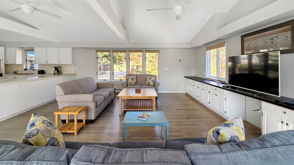 Living room has comfortable seating and large flat screen TV