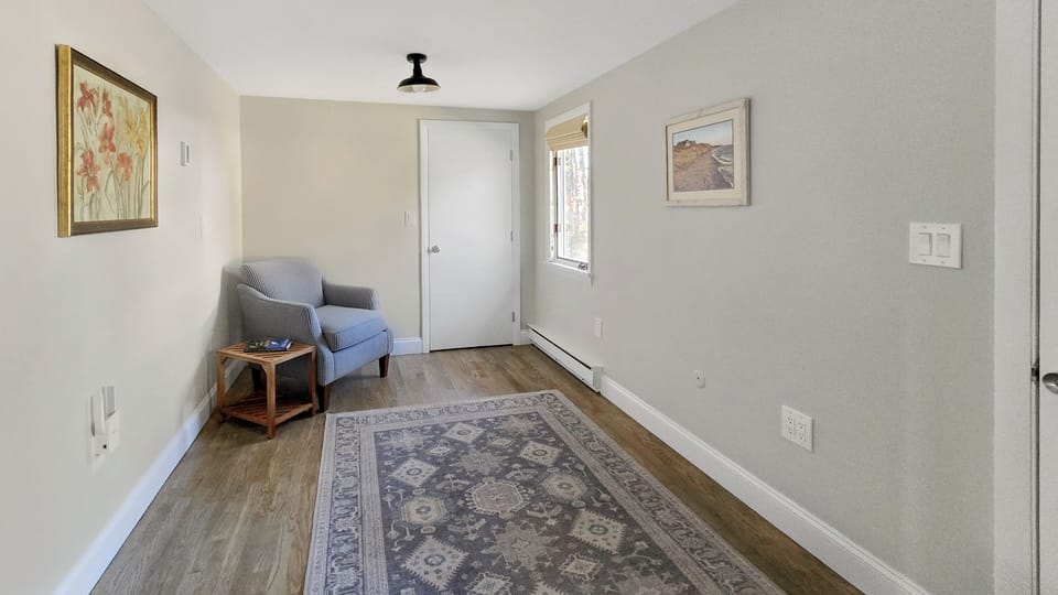 Den/office with comfortable chair wiill have a desk