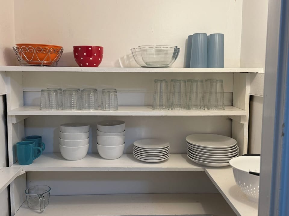Kitchen closet fully stocked with dishes