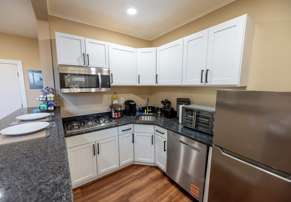 Cook with ease in the modern kitchen featuring granite countertops, stainless-steel appliances, and an instant hot & cold filtered-water tap — a thoughtful touch for tea, coffee, or hydration anytime.