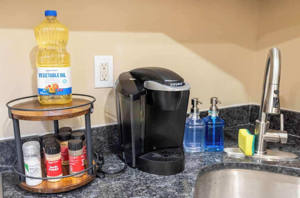 Fully equipped kitchen setup with Keurig and spices for a cozy, homey stay.
