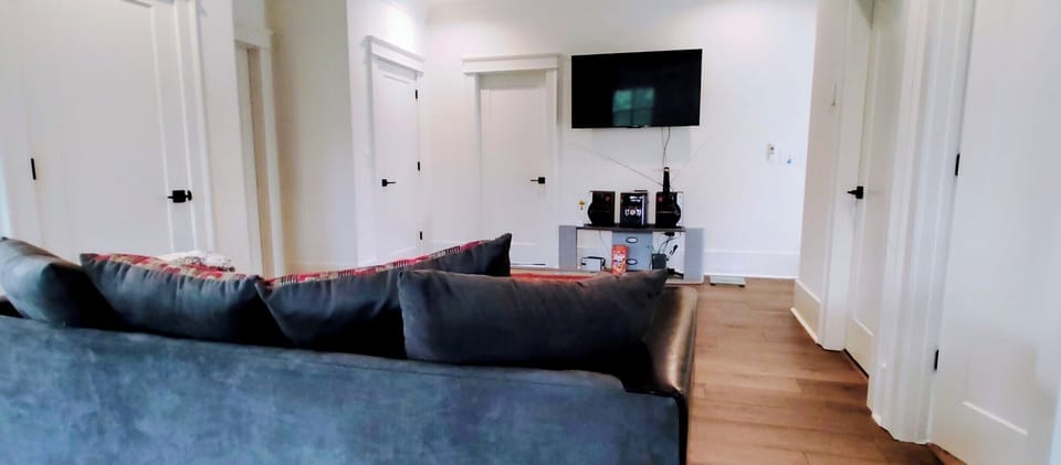 Nook on upper level with couches,  TV, and stereo