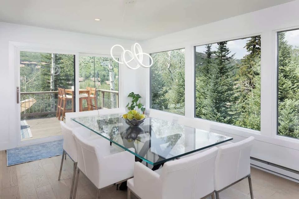 The dining room table seats 8 and has incredible views out the windows. You can access the amazing outdoor patio from the dining area as well. 