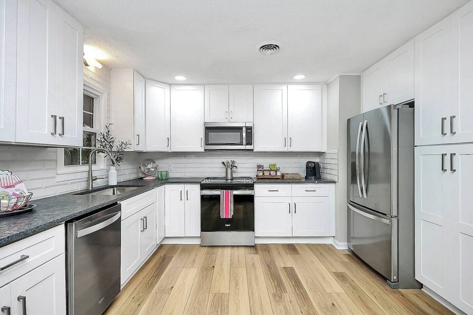 Abundant cabinetry space, tile backsplash adorned with granite countertops paired with Brand NEW Whirlpool stainless steel appliances. 