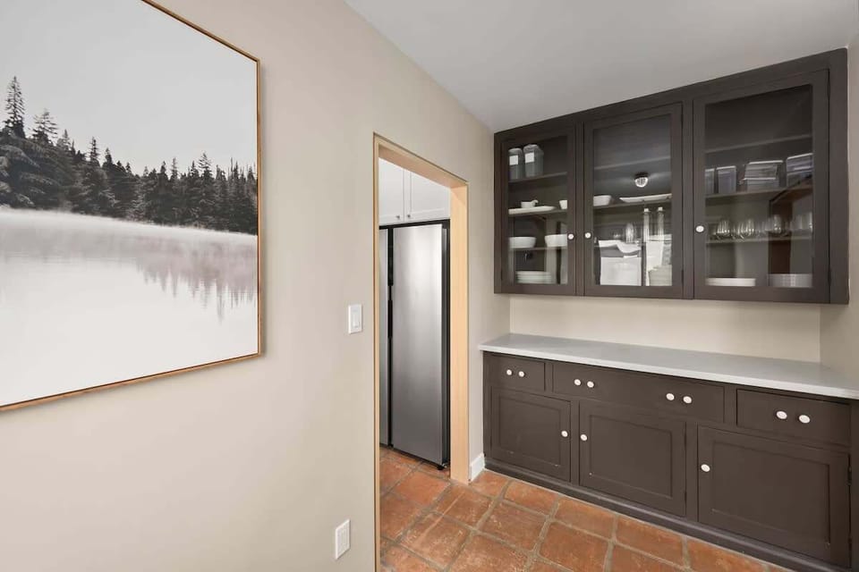 Wet Bar Area with Tasteful Finishes: Host the dinner of your dreams with extra kitchen and entertaining space. Wine glasses, extra plates, we have you covered!