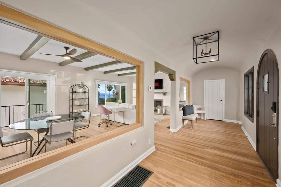 Arched Front Door ways: Welcome to La Casita. This home was created to get the most out of the view by integrating large glass spaces that create the maximum natural light and outward view of the Ocean. This is The front hall. 