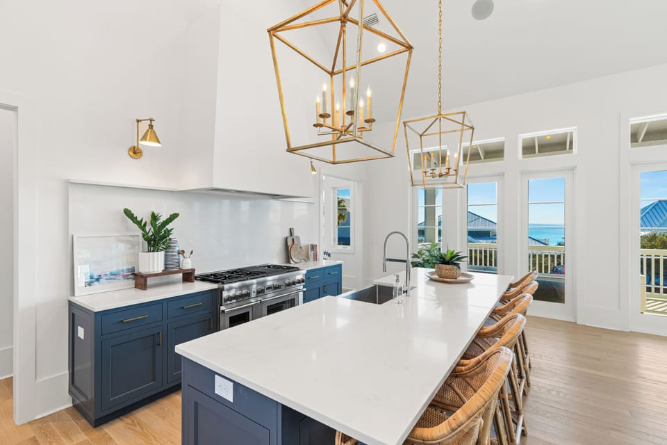 Your dream kitchen awaits with stunning sea views, elegant brass fixtures, and a spacious island perfect for morning coffee and meal prep.