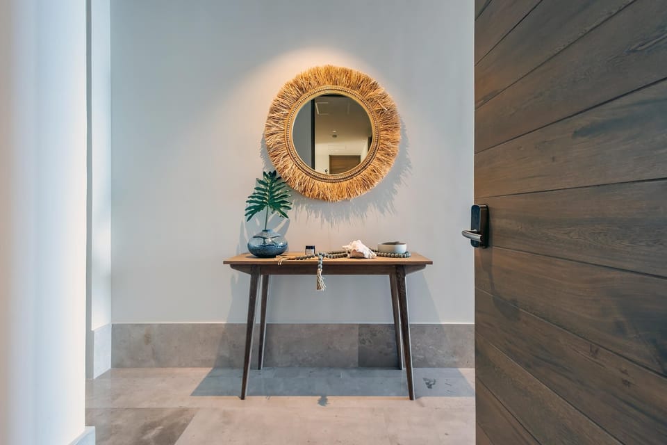 Welcoming entryway with stylish mirror and natural accents