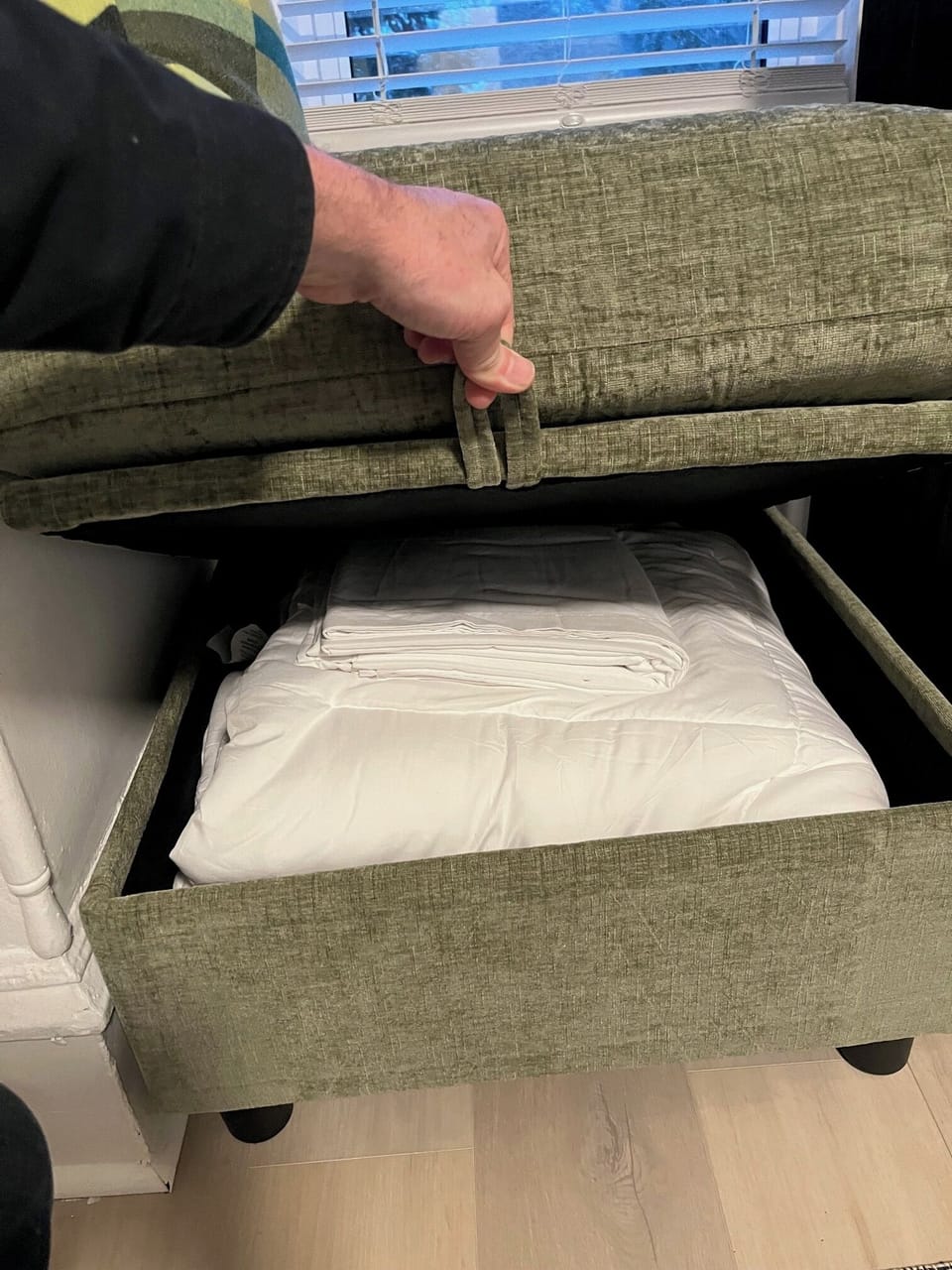 Bedding for the sleeper sofa located in ottoman. 