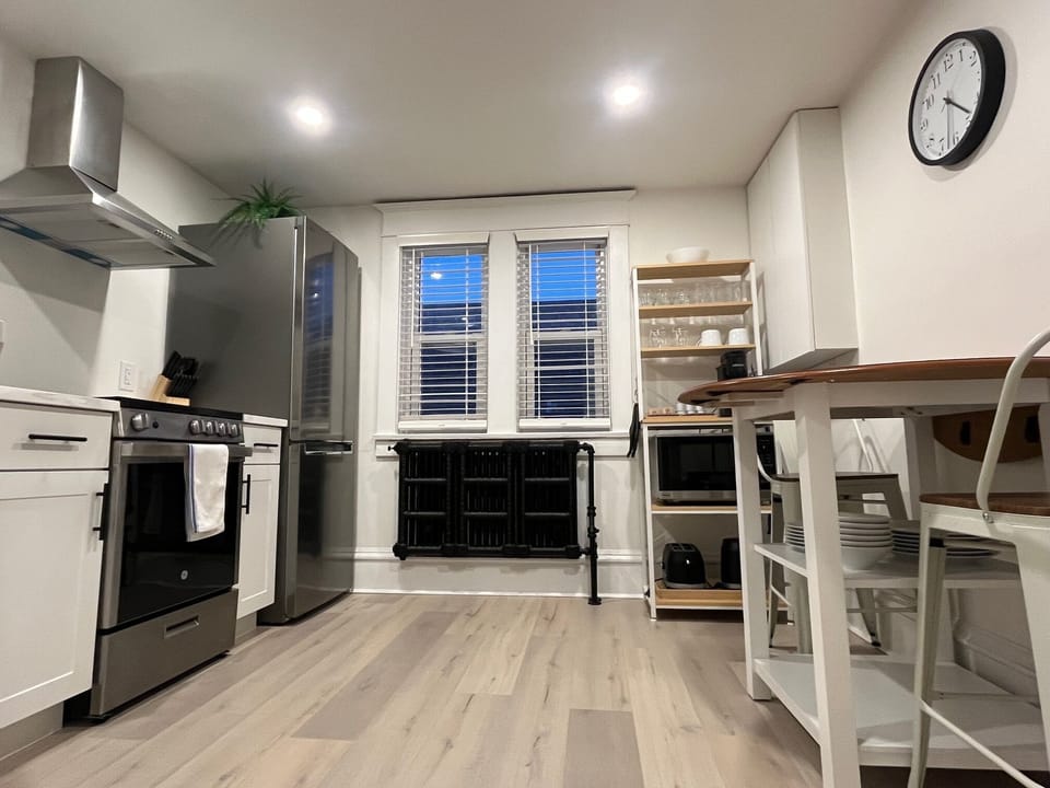 Newly renovated kitchen with quartz counters and stainless steel appliances.