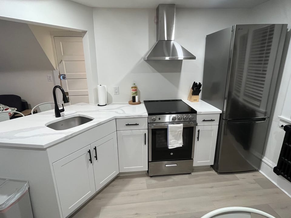 Newly renovated kitchen with quartz counters and stainless steel appliances.