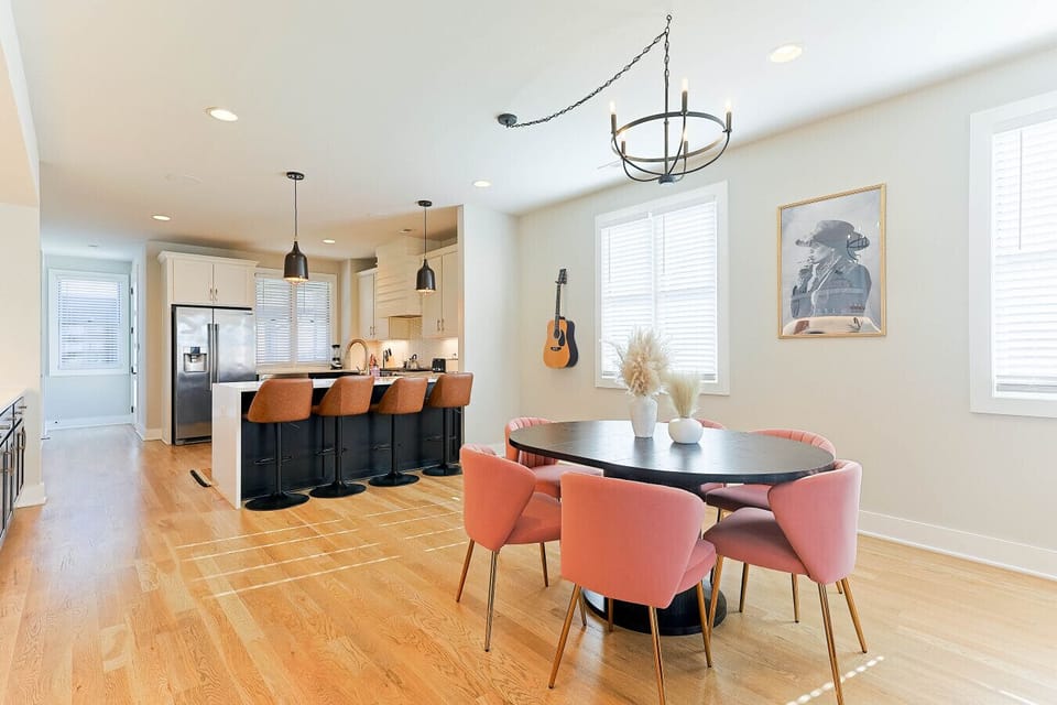 Modern kitchen island with bar seating next to a stylish dining area. 🍽️