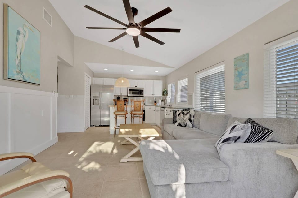 The interior has been completely remodeled in a fresh, modern style with vaulted ceilings, abundant windows and ceiling fans throughout.