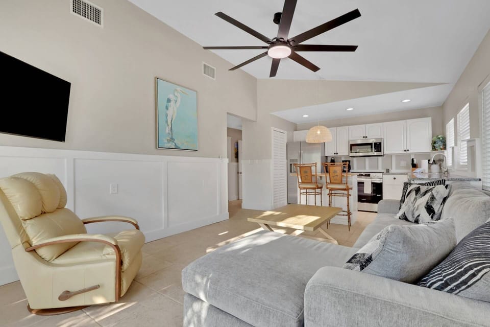 The open living space combines living room, eating bar, and kitchen.