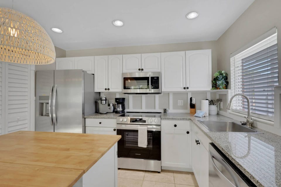 The beautifully updated kitchen is well equipped with upgraded appliances including oven, dishwasher, refrigerator/freezer and microwave.