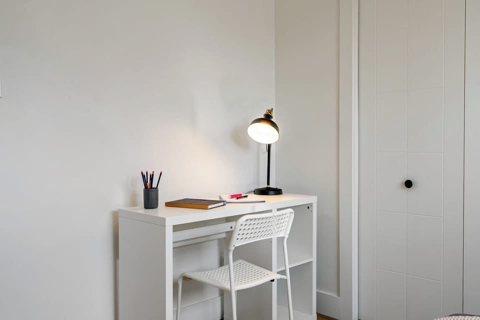 Quiet workspace with desk and lamp perfect for remote work.